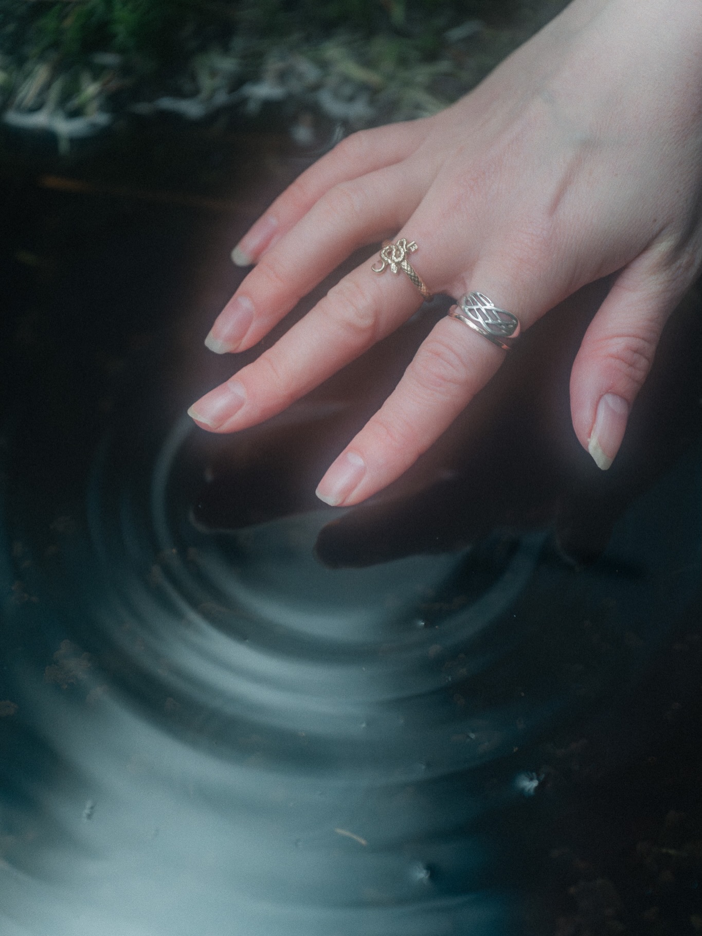 Celtic rings touching dark water