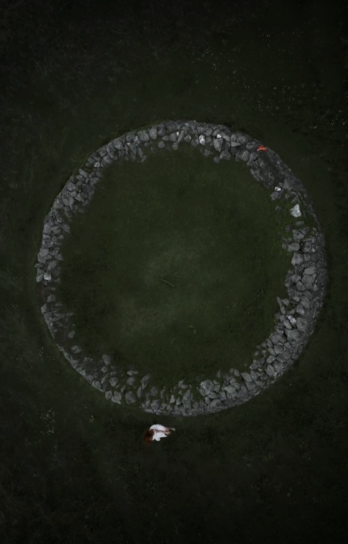 Stone circle — figure lying inside the ring